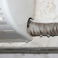 Closeup of the bottom of a ductless AC unit that is leaking water