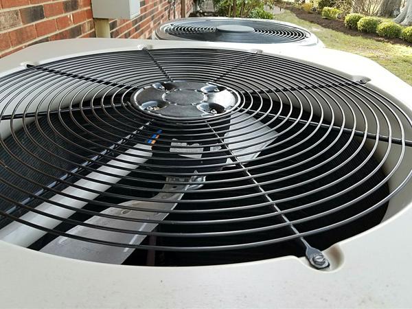 Zoomed in view of the top of an AC unit, that shows some fan blades.