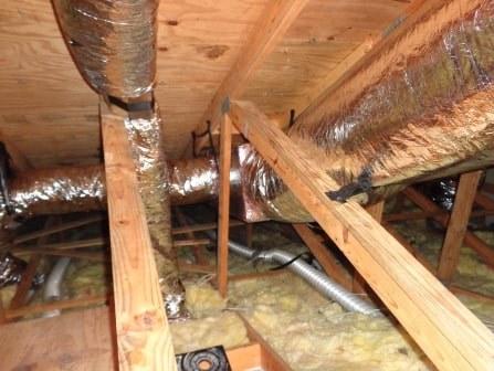 Closeup of ductwork in an insulated attic crawlspace