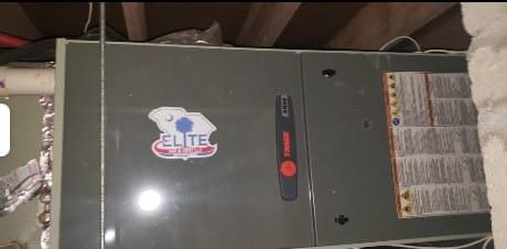 A Trane furnace system with an Elite Air logo sticker on its side