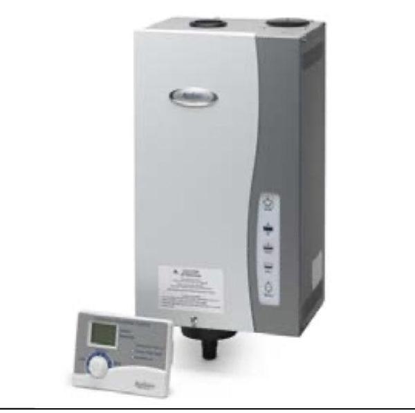 Aprilaire steam humidifier with its digital control panel sitting in front of it.