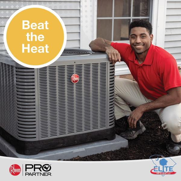 Elite uniformed tech kneeling beside a Rheem AC unit smiling at the camera with a yellow circle on the other side that says Beat the Heat