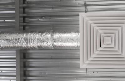 AC duct and vent below corrugated metal roof